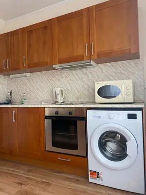 a kitchen with a washing machine and a microwave at Cedar Lodge Apartament - Gondola in Bansko