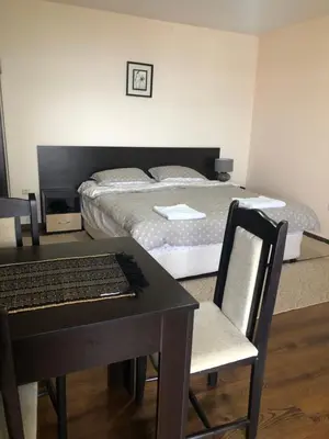 a bedroom with a bed and a desk with a keyboard at Comfortable and affordable big studio in Bansko