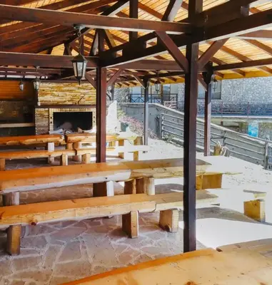 a group of wooden benches in a building at Forestside Stay at Stream Resort in Stoykite