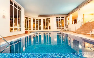 a swimming pool in a house with a building at Forestside Stay at Stream Resort in Stoykite