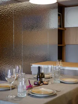 a table with glasses and bottles of wine on it at Sofia Central View Loft in Sofia