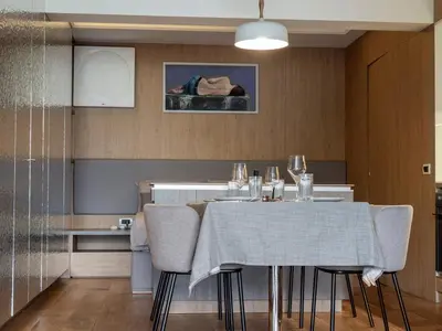 a dining room with a table and chairs in a kitchen at Sofia Central View Loft in Sofia