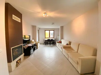 a living room with a couch and a tv at Green Life Private Apartment D27 in Bansko