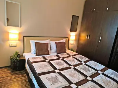 a bedroom with a large bed with two pillows at Warm Evenings and free Bottle of Wine in Perun Lodge in Bansko