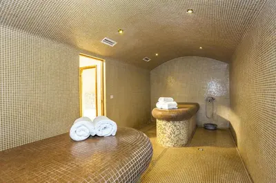 a bathroom with a sink and towels in a room at Warm Evenings and free Bottle of Wine in Perun Lodge in Bansko