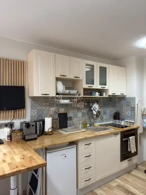 a kitchen with white cabinets and a counter top at Green Line Studio Appartment Pamporovo in Pamporovo