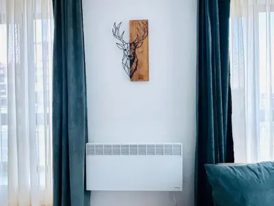 a picture of a deer on a wall next to a window at Bansko 3 Ski To Door Apartment in Bansko