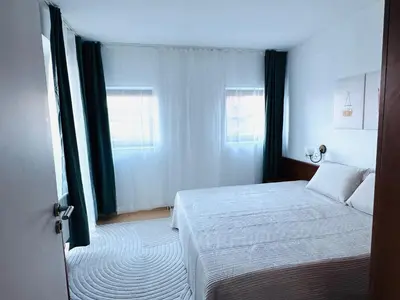 a hotel room with a bed and a window at Bansko 3 Ski To Door Apartment in Bansko