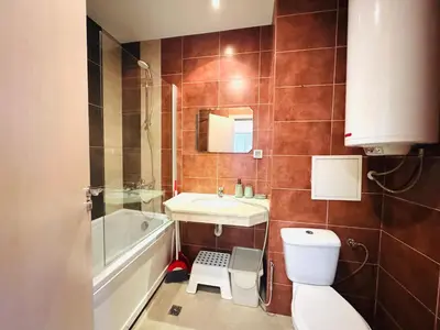 a bathroom with a toilet and a sink and a tub at Bansko 3 Ski To Door Apartment in Bansko