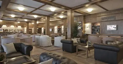 a bar with couches and chairs in a room at Superior studio with terrace in 4star Green Life Bansko in Bansko