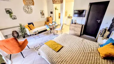 a living room with a couch and a table at Superior studio with terrace in 4star Green Life Bansko in Bansko