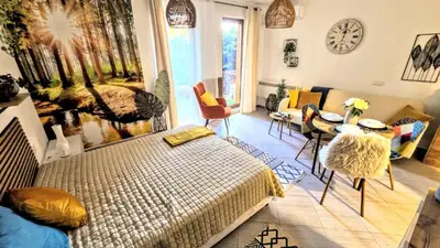a bedroom with a bed and a table and a couch at Superior studio with terrace in 4star Green Life Bansko in Bansko