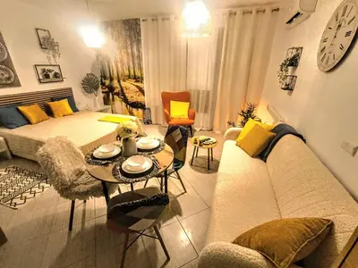 a living room with a couch and a table at Superior studio with terrace in 4star Green Life Bansko in Bansko