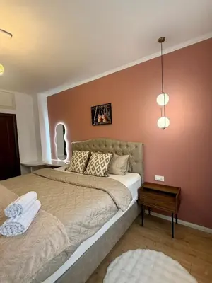 a bedroom with two beds and a table at Apartment Juliet in Sofia