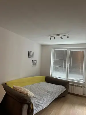 a living room with a couch and a window at GALAXY apartment in Sofia