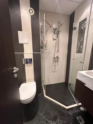 a bathroom with a shower and a toilet and a sink at GALAXY apartment in Sofia