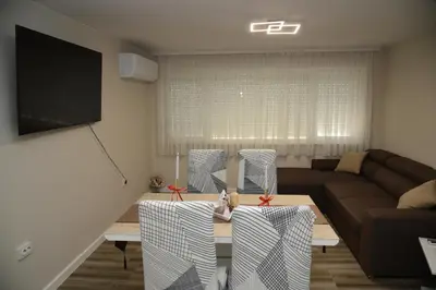 a living room with a table and a couch at C&A Apartment in Gotse Delchev