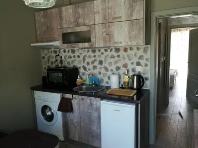 a kitchen with a sink and a washing machine at Studio 11 Plovdiv in Plovdiv