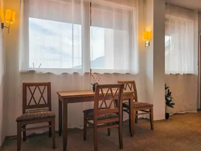 a dining room table with three chairs and a window at EDEL View! 1BR Ap with Top Mountain View in Bansko in Bansko