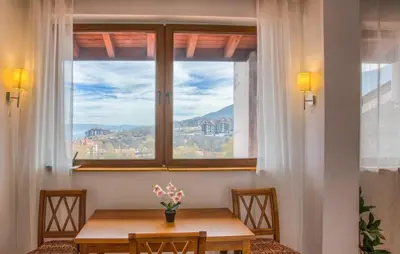 a table in front of a window with a view at EDEL View! 1BR Ap with Top Mountain View in Bansko in Bansko