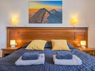a bedroom with a bed with two pillows on it at EDEL View! 1BR Ap with Top Mountain View in Bansko in Bansko
