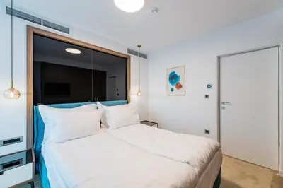 a bedroom with a large bed with white sheets at NOVITA Hotel Sofia FREE UNDERGROUND PARKING in Sofia