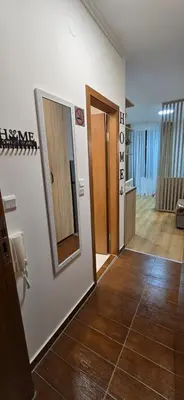 a hallway with a door and a mirror on a wall at Lux Apartment B11 in Bansko