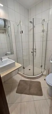 a bathroom with a shower and a tub and a sink at Lux Apartment B11 in Bansko