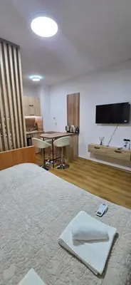a hotel room with a bed with a towel on it at Lux Apartment B11 in Bansko