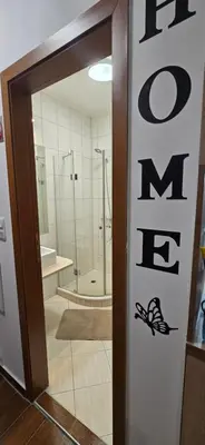 a bathroom with a shower and a door with the word me at Lux Apartment B11 in Bansko