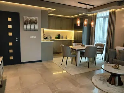 a living room and kitchen with a table and chairs at All Seasons Apartment 2 in Sofia