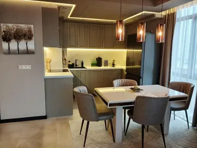 a kitchen and dining room with a table and chairs at All Seasons Apartment 2 in Sofia
