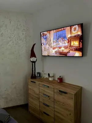 a room with a dresser with a television on the wall at Dream Apart - Iceberg in Pamporovo