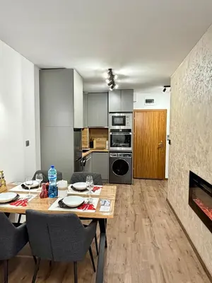 a kitchen and dining room with a table and chairs at Dream Apart - Iceberg in Pamporovo