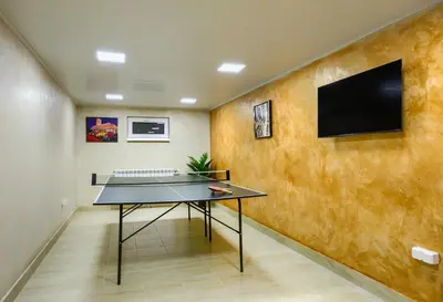 a ping pong table in a room at Rila North Samokov in Samokov