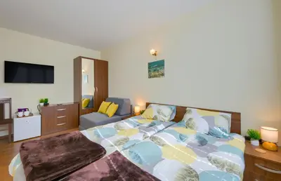 a bedroom with a bed and a couch at Rila North Samokov in Samokov