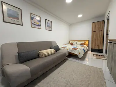 a living room with a couch and a bed at Botev MiniHub Hub 1 Modern Studio at Botev 88 in Sofia
