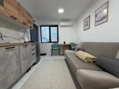 a living room with a couch and a kitchen at Botev MiniHub Hub 1 Modern Studio at Botev 88 in Sofia