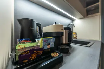 a kitchen counter with a coffeemaker and a coffee maker at Exclusive Luxury Central Apartment in Sofia