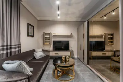 a living room with a couch and a table at Exclusive Luxury Central Apartment in Sofia