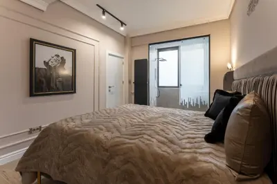 a bedroom with a large bed with a picture on the wall at Exclusive Luxury Central Apartment in Sofia