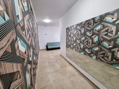 a room with a wall with a mural of a building at Flex loft in Sofia