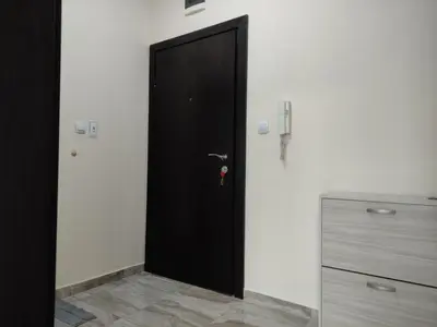 a black door in a room with a dresser at Апартамент за гости НИКОЛОВА in Plovdiv