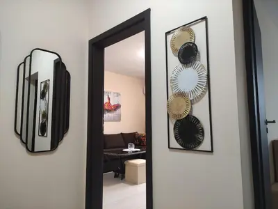 a mirror on a wall next to a room at Апартамент за гости НИКОЛОВА in Plovdiv