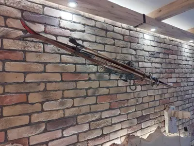 an old baseball bat hanging on a brick wall at Alpin Art Studio in Hotel Iceberg - Free Pool, Sauna and Fitness in Borovets