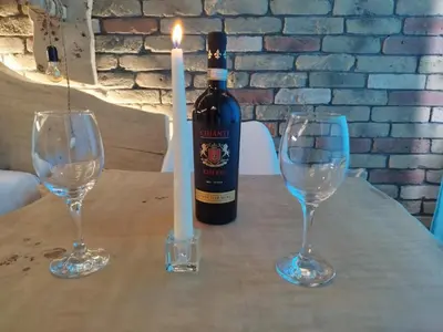 a bottle of wine and two wine glasses on a table at Alpin Art Studio in Hotel Iceberg - Free Pool, Sauna and Fitness in Borovets