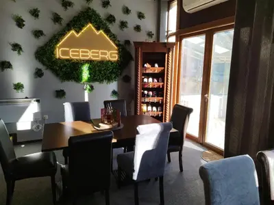a dining room with a table and a sign on the wall at Alpin Art Studio in Hotel Iceberg - Free Pool, Sauna and Fitness in Borovets