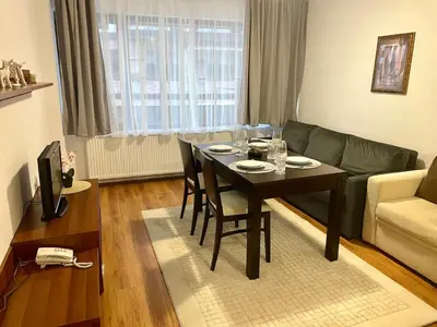 a living room with a table and a couch at The Cozy Spot by the Ski Lift Gondola by SI Stay in Bansko