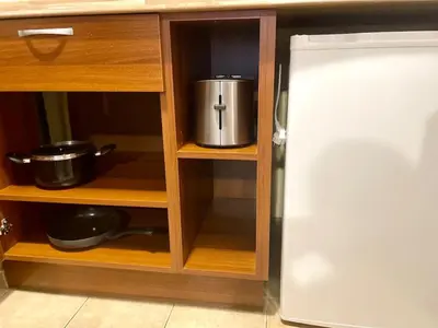 a kitchen cabinet with a pot on a shelf at The Cozy Spot by the Ski Lift Gondola by SI Stay in Bansko