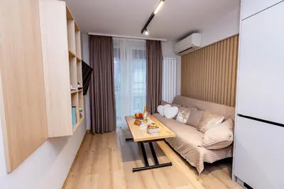 a small living room with a couch and a table at City Home Sandanski in Sandanski